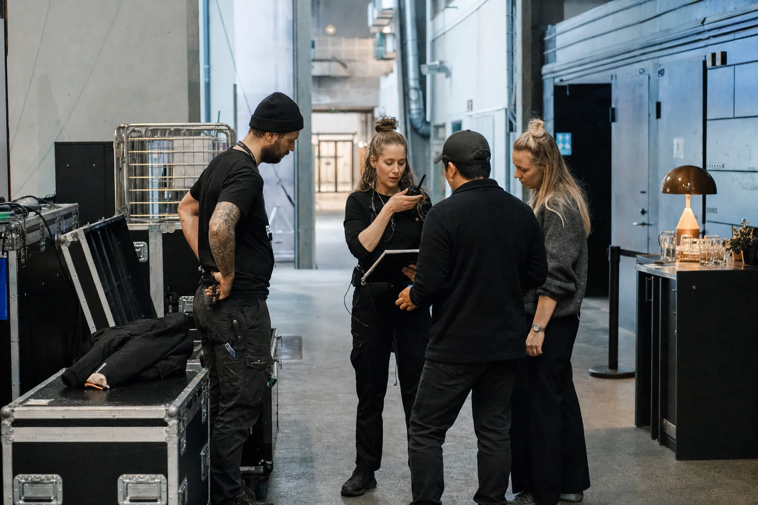 The event crew holds a briefing with the coordinator backstage before the doors open